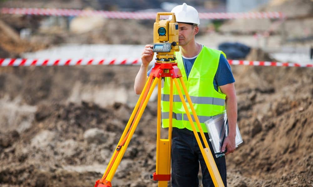 Surveyor performing a construction survey on a Vermont construction site